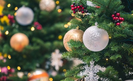 close up image of a holiday tree with gold and white ball ornaments