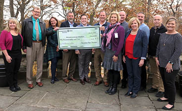 Minnesota Landscape Arboretum staff pose with a large check from International Paper Foundation