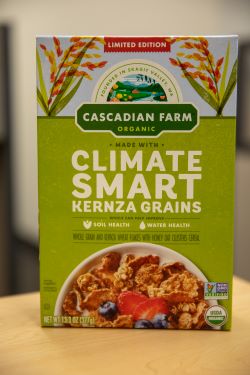 Front of box of Cascadian Farm KernzaⓇ Flakes with Honey Oat Clusters Cereal.