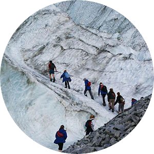Students hiking in New Zealand up a rocky, icy mountain