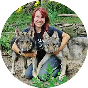 Alumna Roberta Ryan with two wolves.
