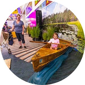 Little kid takes a selfie in the CFANS canoe at the MN State Fair.