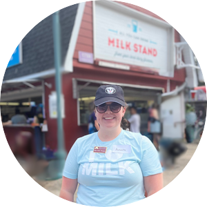 A photo of Amara Livingston in front of the All You Can Drink Milk Stand at the Minnesota State Fair