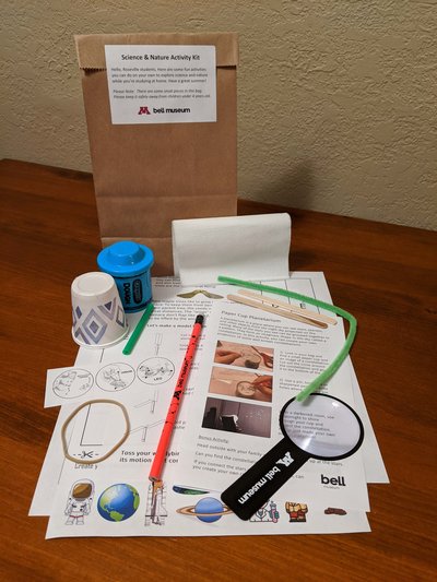 Bell Museum activity kit contents, including magnifying glass and other materials for at-home discovery.