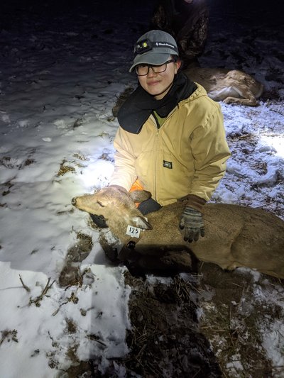Fisheries, wildlife and conservation biology alumna Clare Tan Yi Fang with a tagged deer.