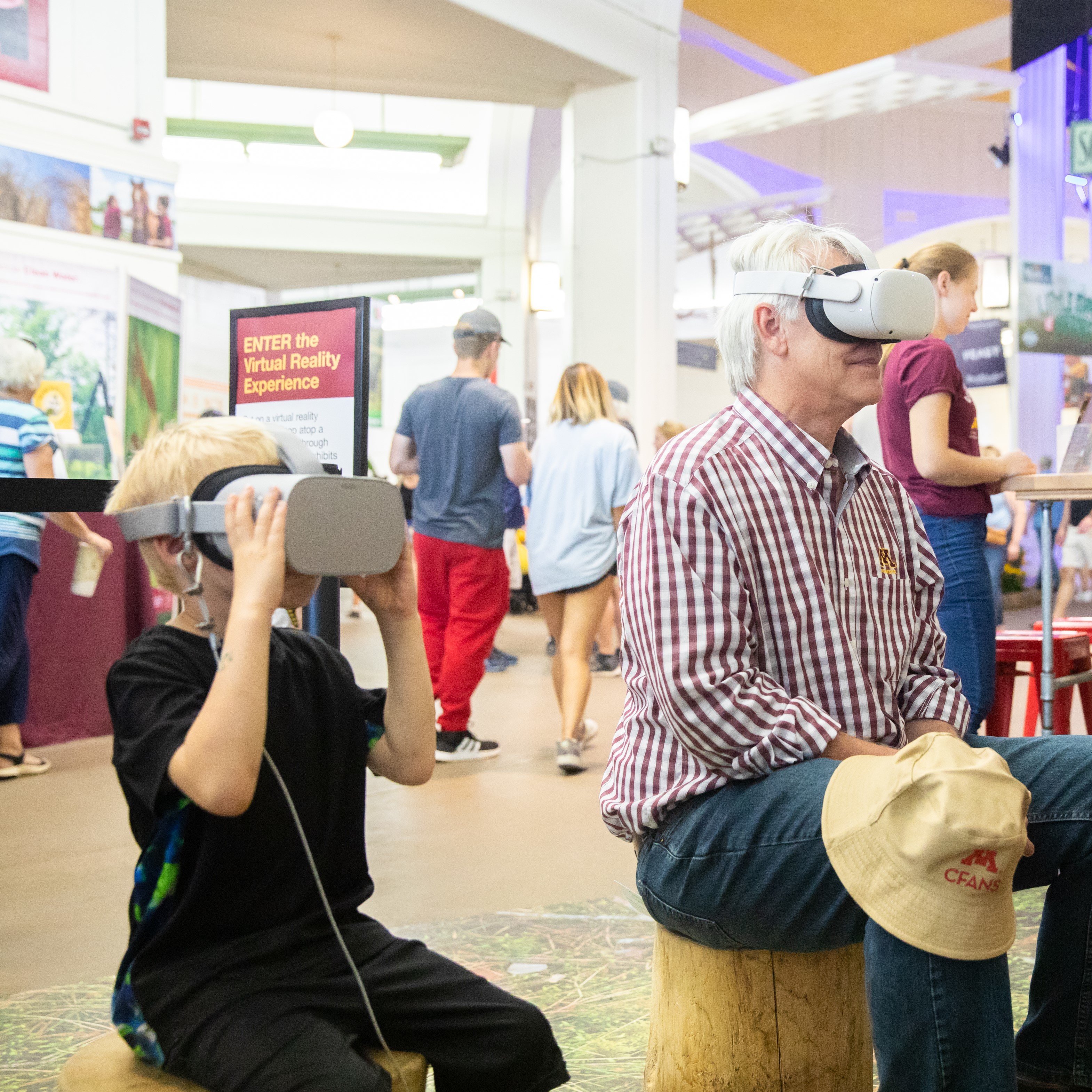 A photo of two State Fair visitors experiencing virtual reality