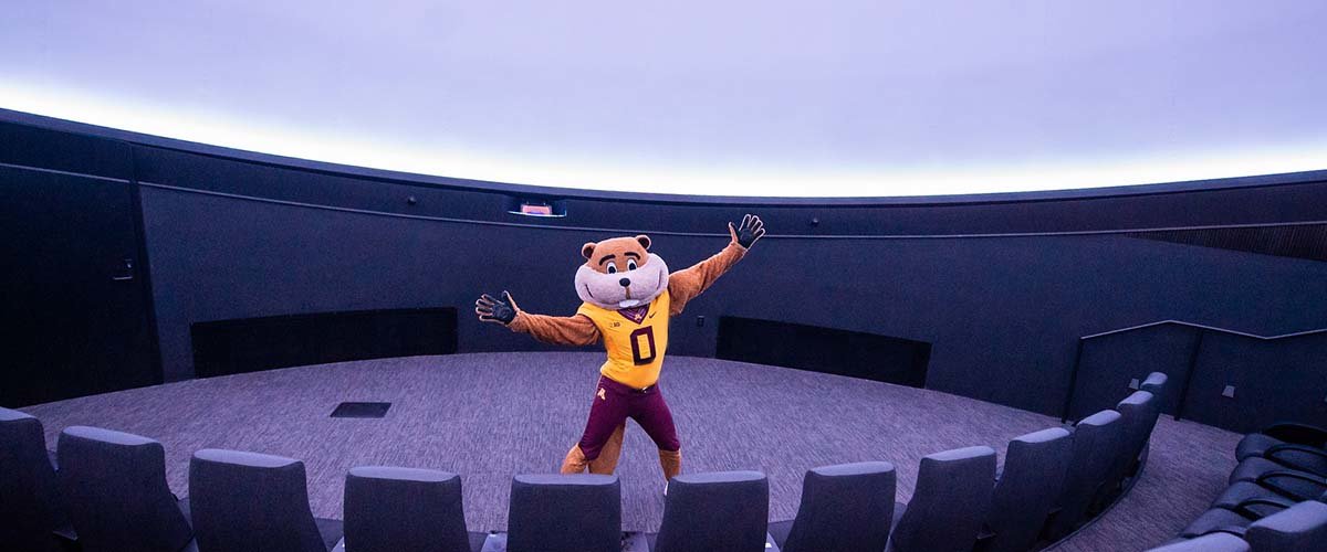 Goldy Gopher stands on stage at the Whitney and Elizabeth MacMillan Planetarium at the Bell Museum. 