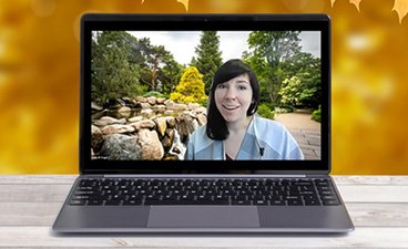 Picture of a woman standing in a garden on a laptop screen. 