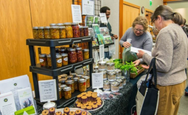An arboretum visitor shops at a handmade food vendor at a previous year's December gift market