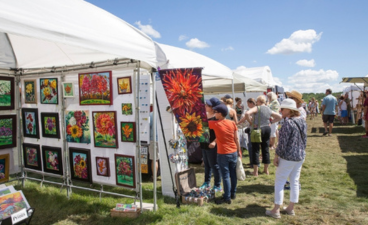 People browse artists' stalls and wares at a previous art in the gardens event