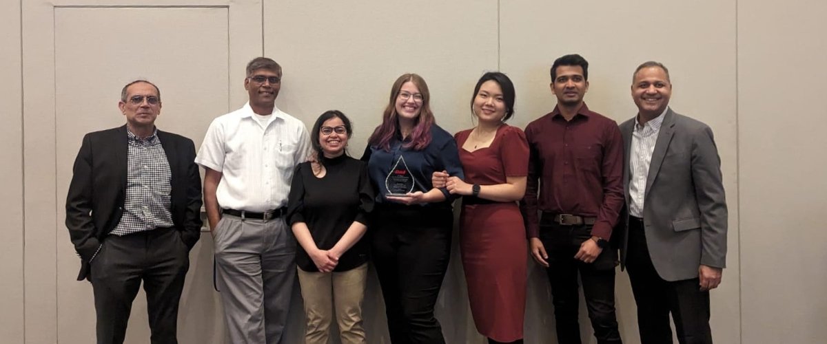 Yay-tøst team. and staff pose with award