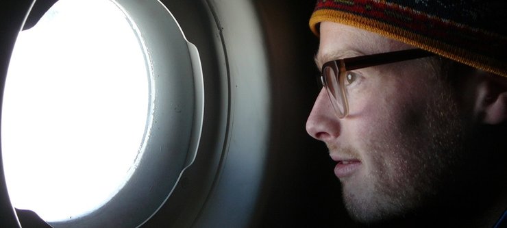 Peter Neff looking out an airplane window.