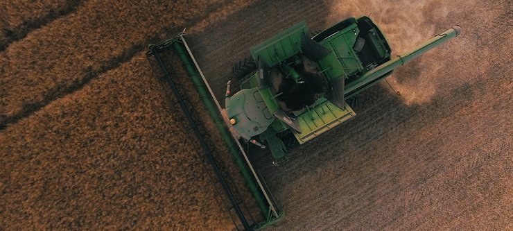 Combine removing wheat from an aerial view.