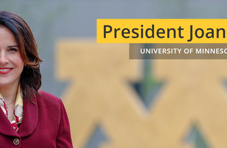 President Gabel stands in front of a Block M with the words, "President Joan T.A. Gabel: University of Minnesota System."