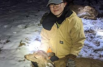 Fisheries, wildlife and conservation biology alumna Clare Tan Yi Fang with a tagged deer.