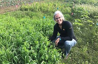 Horticultural science professor Julie Grossman near cover crops at Big River Farms.