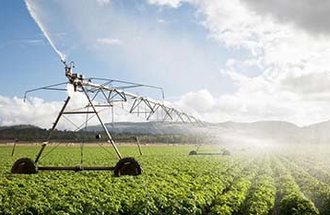 Irrigation system spraying crops. Photo by George Clerk from Getty Images.