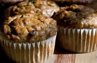 A cluster of muffins with raisins in them.