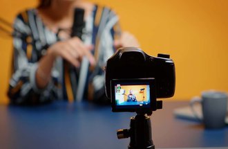 Video blogger recording content on a camera.