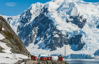 Research station nestled among the ice-capped mountains in Antarctica.