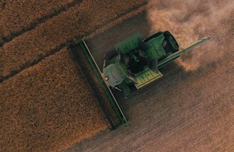 Combine removing wheat from an aerial view.