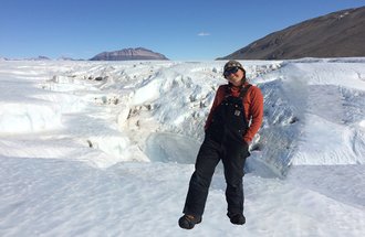 Heidi Roop standing on a glacier in Antarctica while doing field work. 