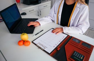 Dietitian working at a laptop. 