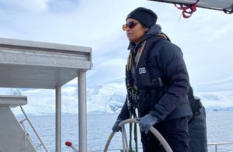 Sushma Reddy navigating a boat in the Southern Ocean