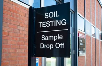 Sign outside of building that says Soil Testing Sample Drop Off